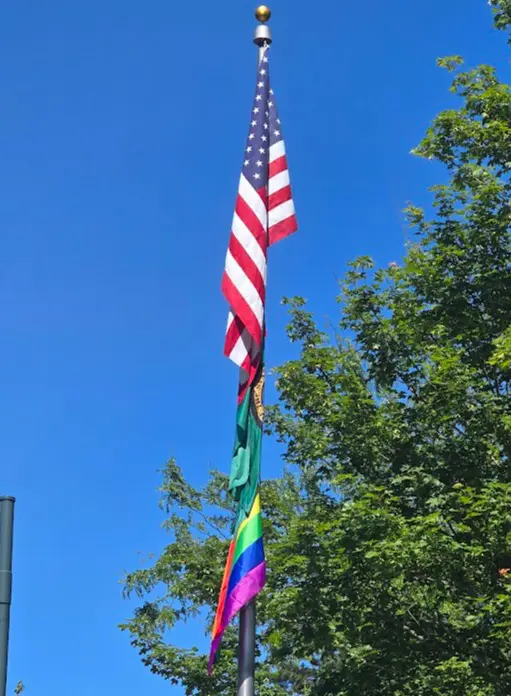 The American flag, Washington  flag, and the Pride flag together